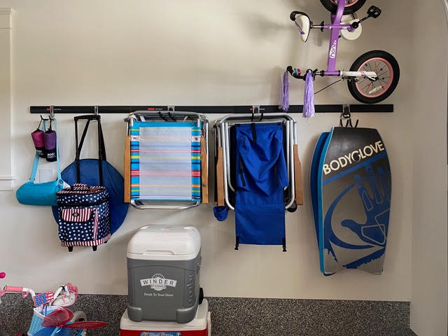 Hang it up! Install FastTrac from Rubbermaid, available at Home Depot and get it off the floor!  Easy, Versatile and Efficient!